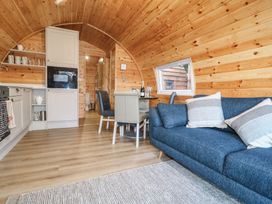A combined living and kitchen area with a sofa and dining table at Park View Lodge