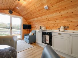 A kitchen with a sofa and television at Park View Lodge