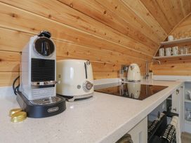 A kitchen with coffee machine, toaster, kettle, and stove at Park View Lodge