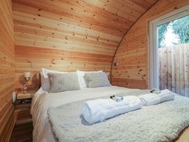 A bedroom with a bed and wooden walls at Park View Lodge