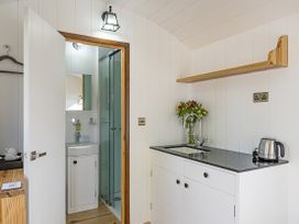 A kitchenette with a sink and kettle at No 1 The Orchard in Upton Warren