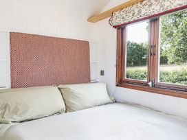 A bedroom with a bed and window at No 1 The Orchard Upton Warren