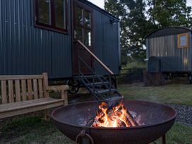 An outdoor area with a fire pit and a bench at No 1 The Orchard Upton Warren