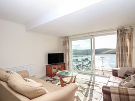 A living room with a sofa and television at 6 Avon Quillet in Bigbury-On-Sea
