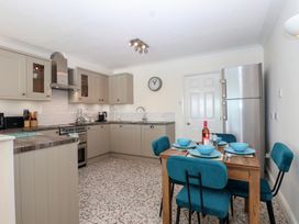 A kitchen with appliances and dining area at 6 Avon Quillet Bigbury-On-Sea