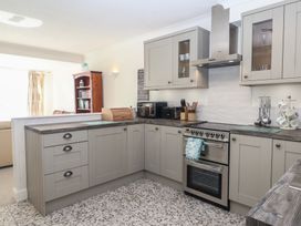 A kitchen with cabinets, an oven, and a microwave at 6 Avon Quillet in Bigbury-On-Sea