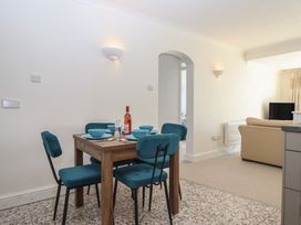 A dining room with a table set for four at 6 Avon Quillet Bigbury-On-Sea