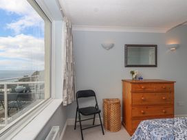 A bedroom with a dresser and a chair at 6 Avon Quillet Bigbury-On-Sea