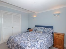 A bedroom with a bed and nightstands at 6 Avon Quillet in Bigbury-On-Sea