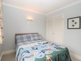 A bedroom with a bed and closet at 6 Avon Quillet Bigbury-On-Sea