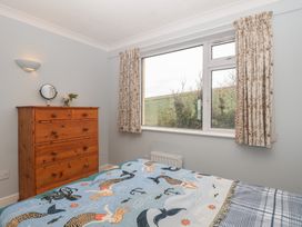 A bedroom with a bed and dresser at 6 Avon Quillet Bigbury-On-Sea