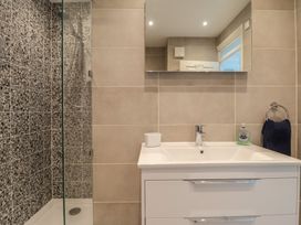 A bathroom with a shower and sink at 6 Avon Quillet Bigbury-On-Sea