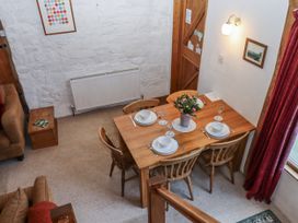 A dining room with a table set for dinner at Swallows Nest in Widecombe-in-the-Moor near Postbridge