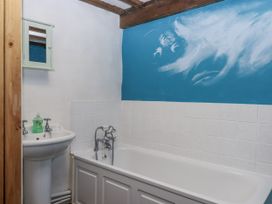 A bathroom with a bathtub and sink at Swallows Nest in Widecombe-in-the-Moor near Postbridge