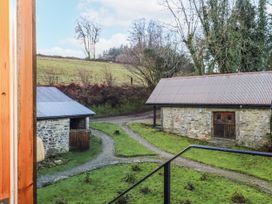 View of the yard with buildings and trees at Swallows Nest in Widecombe-in-the-Moor near Postbridge