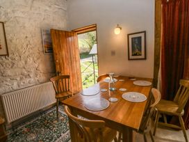 A dining room with a table and chairs at Swallows Nest in Widecombe-in-the-Moor near Postbridge