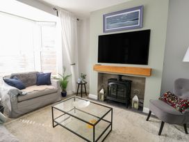 A living room with a sofa and a coffee table at Bryn Y Mor in Beaumaris