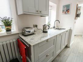 A kitchen with a kettle and toaster on the countertop at Bryn Y Mor in Beaumaris