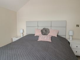 A bedroom with a bed and bedside tables at Bryn Y Mor Beaumaris
