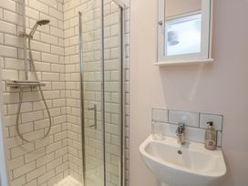 A bathroom with a shower and sink at Bryn Y Mor Beaumaris