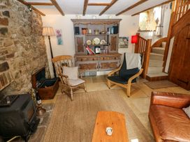 A living room with a rocking chair and a coffee table at 1 Mill Farm Cottages Narberth
