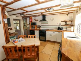 A kitchen with a table and chairs at 1 Mill Farm Cottages in Narberth
