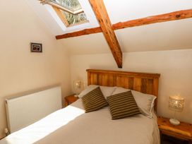 A bedroom with a double bed and skylight at 1 Mill Farm Cottages in Narberth