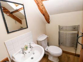 A bathroom with a sink and toilet at 1 Mill Farm Cottages Narberth