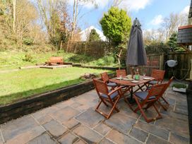 A garden with a table and chairs at 1 Mill Farm Cottages in Narberth