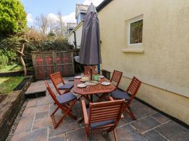 An outdoor dining area with a table and chairs at 1 Mill Farm Cottages Narberth