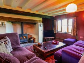 A living room with a sofa, coffee table, and television at Town Farm