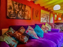 A living room with a sofa and paintings at Town Farm