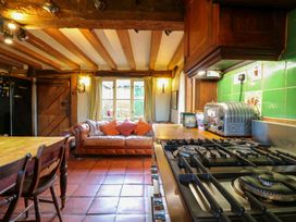 A kitchen with a stove and table at Town Farm