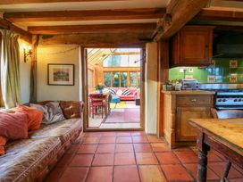 A kitchen with a sofa and dining area visible at Town Farm