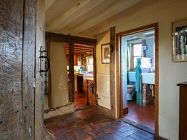 A hallway with a view of a kitchen and bathroom at Town Farm in 