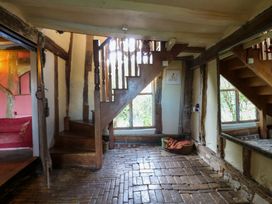 An entrance hall with staircase and brick floor at Town Farm 