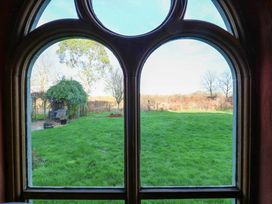 A view of grass and trees through a window at Town Farm