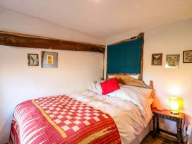 A bedroom with a bed and wall art at Town Farm in 