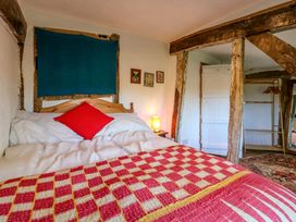 A bedroom with a bed and bedside table at Town Farm in 