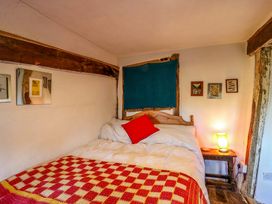 A bedroom with a bed and lamp at Town Farm