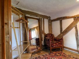 A living room with a mirror and chair at Town Farm