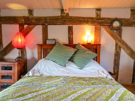 A bedroom with a bed and bedside lamp at Town Farm