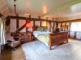 A bedroom with a bed and armchair at Town Farm