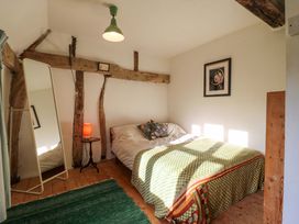 A bedroom with a bed and mirror at Town Farm in 