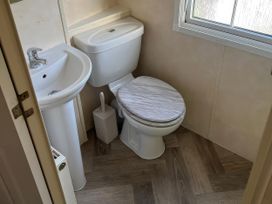 A bathroom with a toilet and sink at Gainc Bach in Abergele