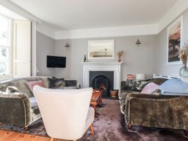 A living room with a sofa and television at Rosedale in St. Ives