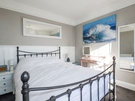 A bedroom with a bed and nightstand at Rosedale St. Ives