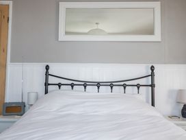 A bedroom with a bed and lamp at Rosedale in St. Ives
