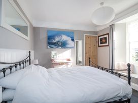 A bedroom with a bed and a table at Rosedale in St. Ives