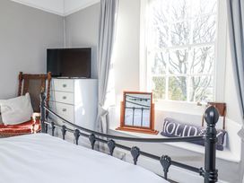 A bedroom with a bed and television at Rosedale in St. Ives